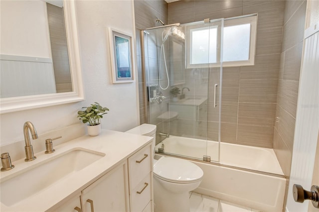 full bathroom with vanity, shower / bath combination with glass door, and toilet