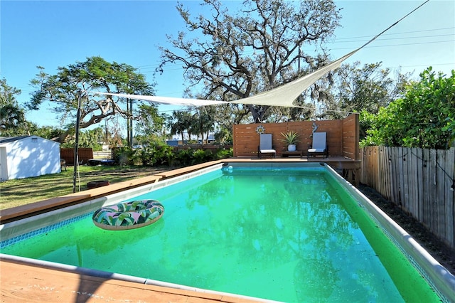 view of swimming pool featuring a shed