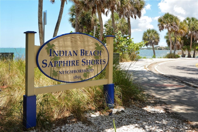 community sign with a water view