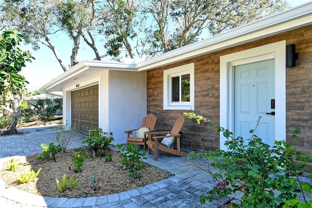 view of exterior entry with a garage