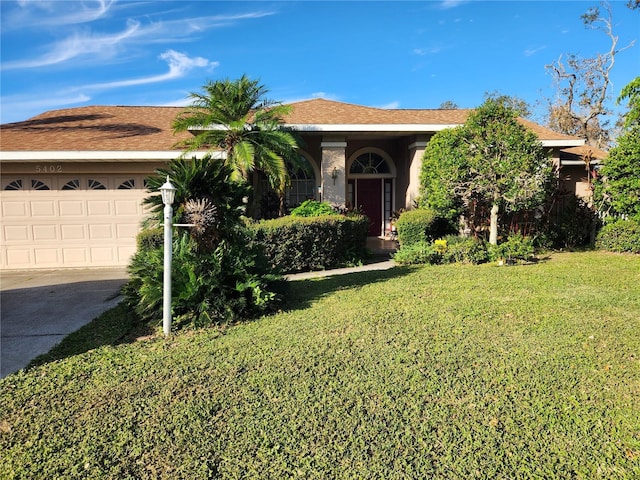 view of front facade featuring a front lawn and a garage