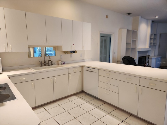 kitchen with white cabinetry, sink, white dishwasher, and light tile patterned floors