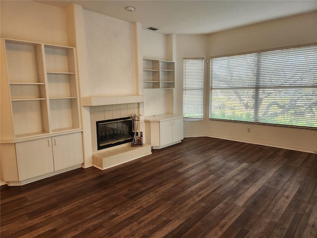 unfurnished living room with dark hardwood / wood-style flooring and a fireplace