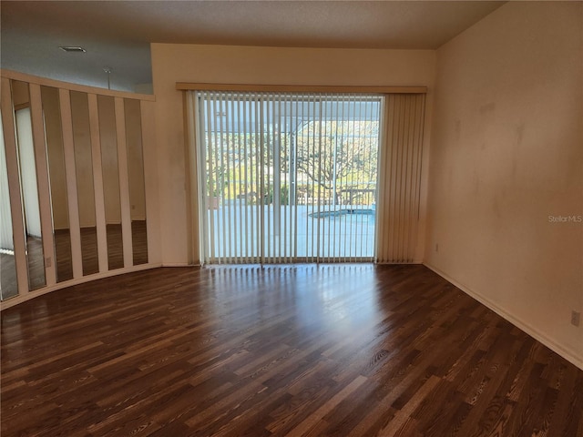 spare room with dark wood-type flooring