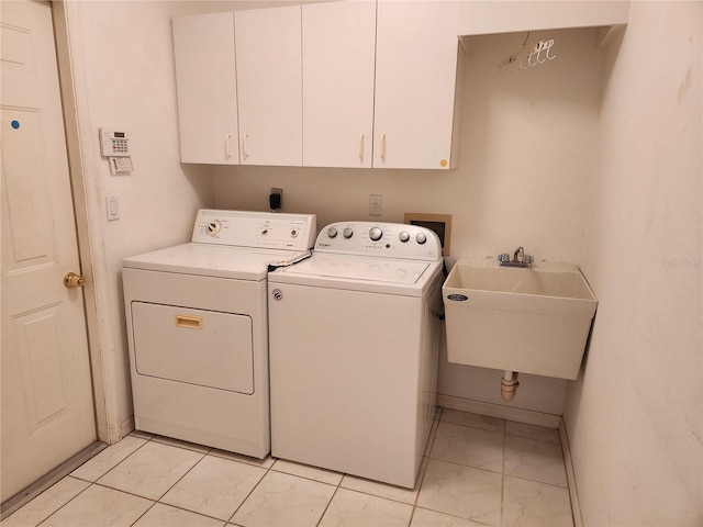 washroom featuring light tile patterned flooring, cabinets, independent washer and dryer, and sink