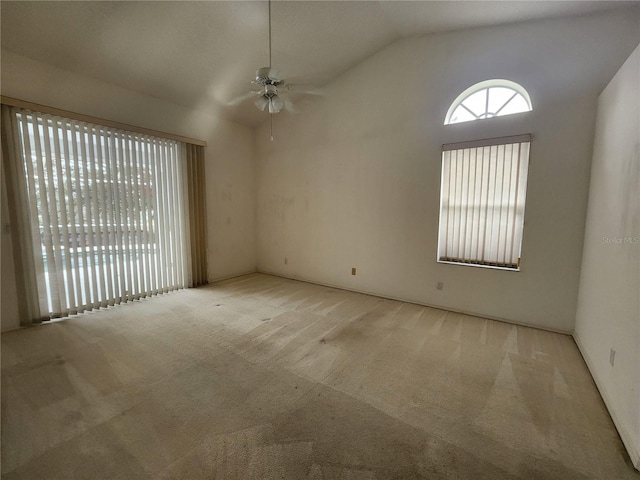 empty room featuring light carpet, vaulted ceiling, and ceiling fan