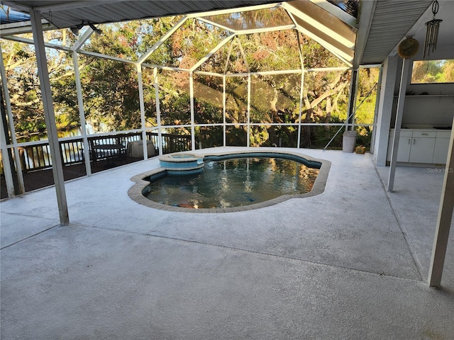 view of pool with a lanai, a patio area, and an in ground hot tub