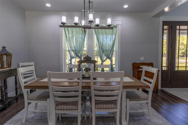 dining space with an inviting chandelier and dark hardwood / wood-style floors