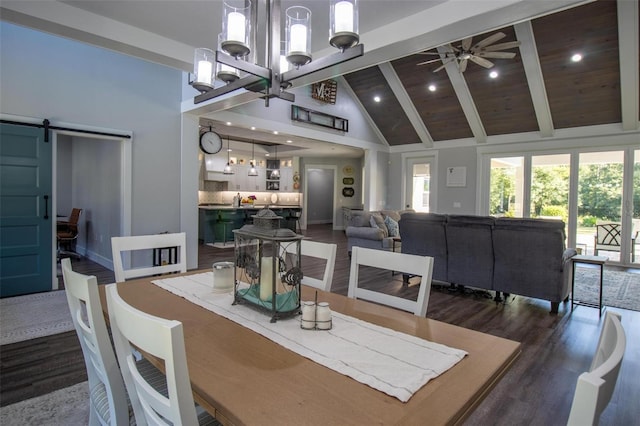 dining space featuring beam ceiling, wood ceiling, dark hardwood / wood-style flooring, a barn door, and ceiling fan with notable chandelier