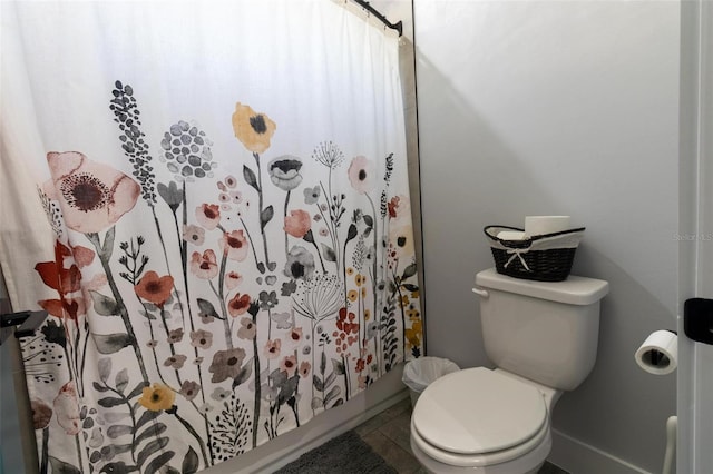 bathroom featuring toilet and tile patterned flooring