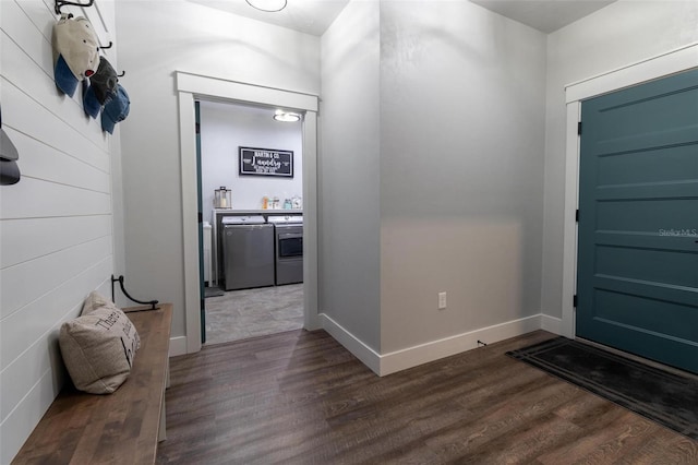 entrance foyer with dark hardwood / wood-style flooring and washing machine and clothes dryer