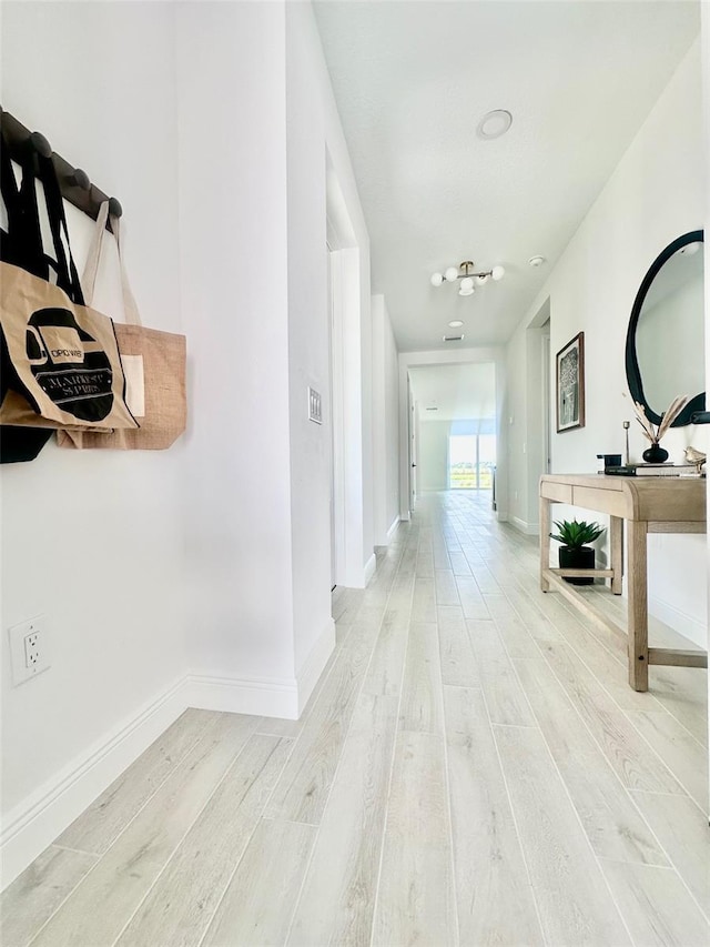 hall with wood-type flooring