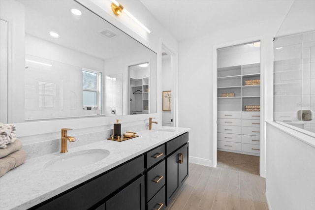 bathroom with vanity, hardwood / wood-style floors, and a shower