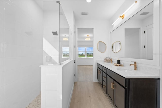 bathroom featuring vanity, hardwood / wood-style floors, and a shower