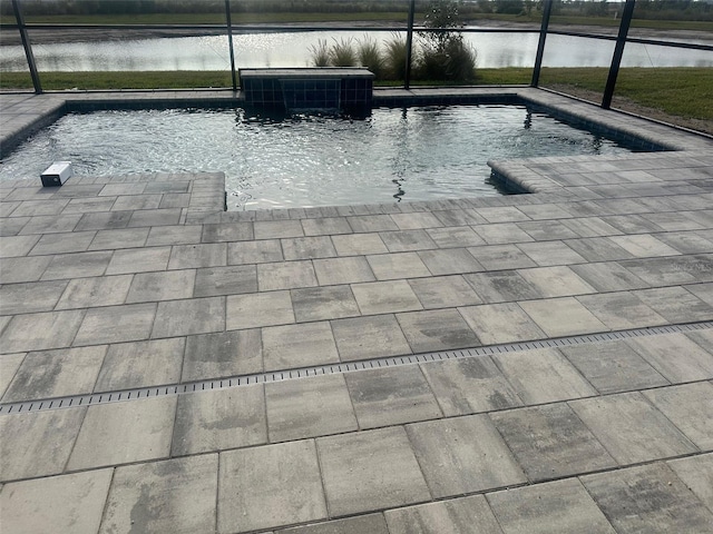 view of swimming pool with a water view, a patio area, central air condition unit, and a lanai