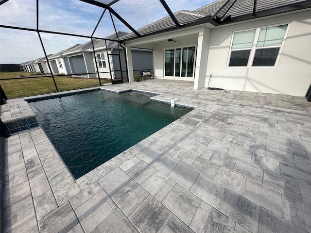 view of pool with a yard, a lanai, a patio area, and ceiling fan