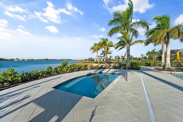 view of pool featuring a water view and a patio