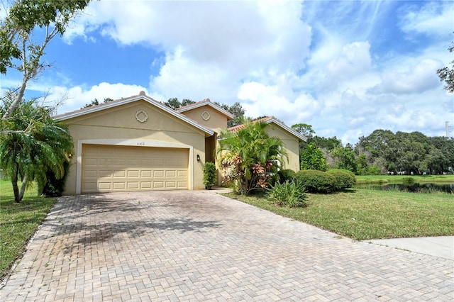 view of front of house featuring a garage and a front lawn