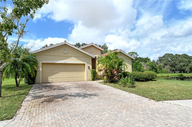 view of front of property with a front lawn and a garage