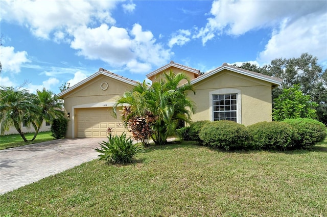 view of front facade with a garage and a front lawn