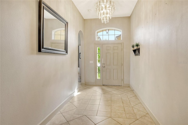 tiled entryway with an inviting chandelier