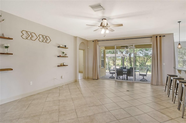 unfurnished room with ceiling fan and light tile patterned floors