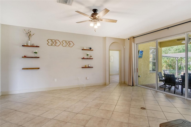 tiled empty room with ceiling fan