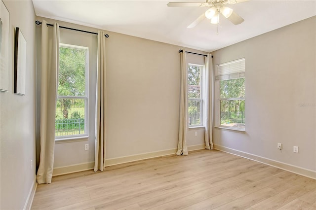 spare room featuring light hardwood / wood-style floors and ceiling fan