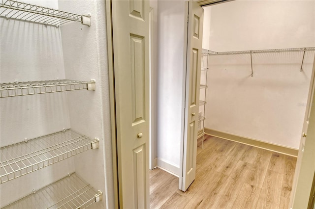 walk in closet featuring wood-type flooring