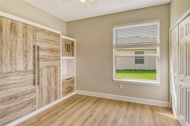 unfurnished room with light hardwood / wood-style flooring and ceiling fan