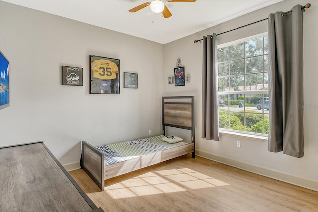 bedroom featuring light hardwood / wood-style flooring, multiple windows, and ceiling fan