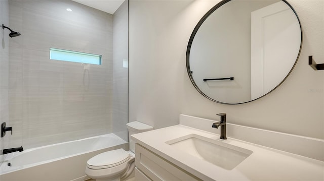 full bathroom featuring tiled shower / bath, vanity, and toilet