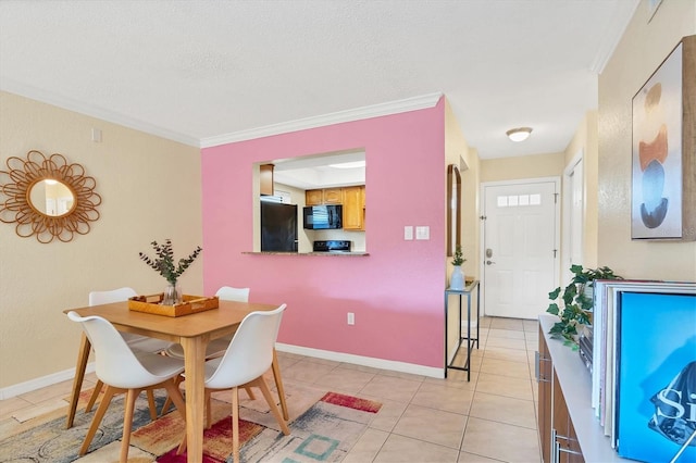 tiled dining room featuring a textured ceiling and crown molding