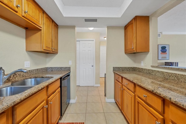 kitchen with light stone countertops, a raised ceiling, sink, light tile patterned floors, and dishwasher