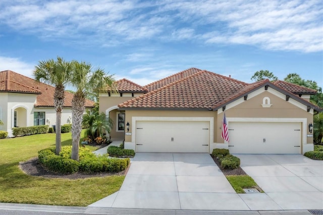 mediterranean / spanish-style house featuring a front yard and a garage