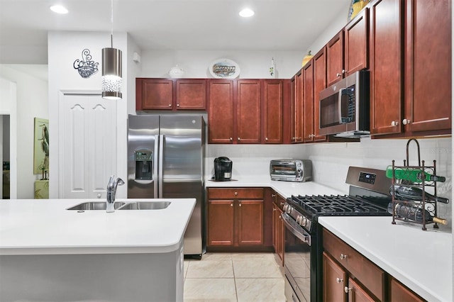 kitchen featuring pendant lighting, sink, decorative backsplash, appliances with stainless steel finishes, and light tile patterned floors