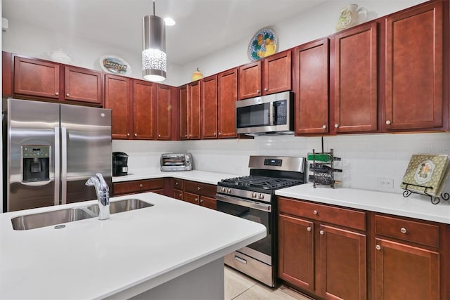 kitchen with decorative backsplash, sink, light tile patterned flooring, pendant lighting, and appliances with stainless steel finishes