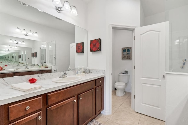 bathroom with a tile shower, vanity, tile patterned flooring, and toilet