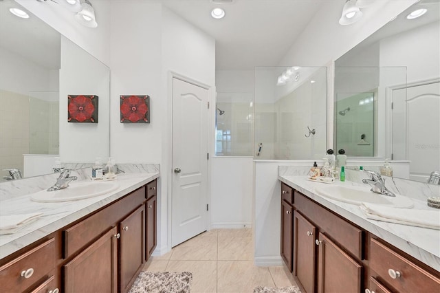 bathroom with tile patterned flooring, vanity, and tiled shower