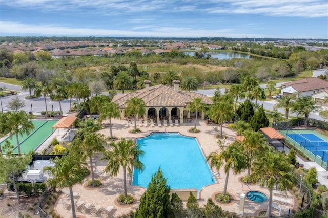 view of swimming pool featuring a water view and a patio