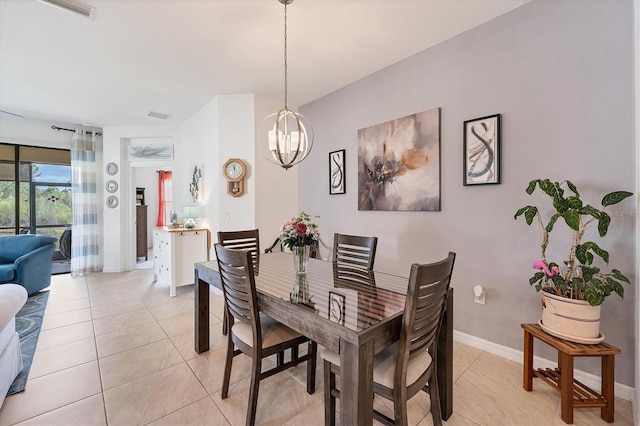 dining room with light tile patterned floors, baseboards, visible vents, and an inviting chandelier