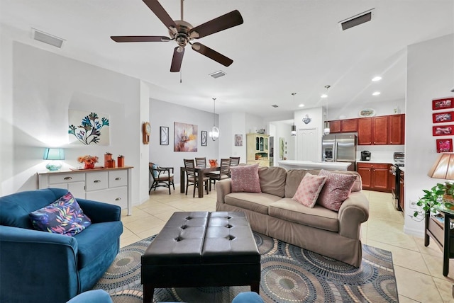 living area with light tile patterned floors, a ceiling fan, visible vents, and recessed lighting