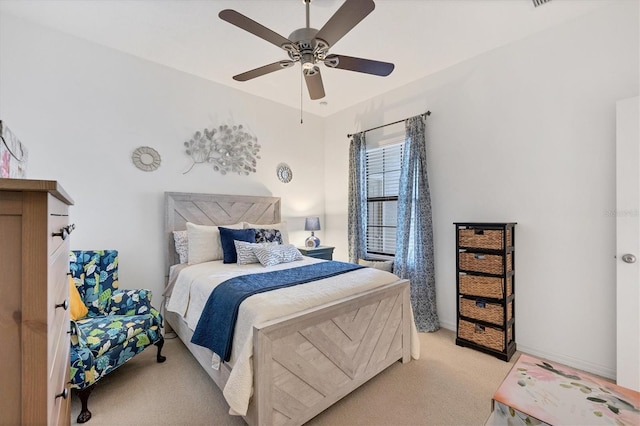 bedroom with ceiling fan, baseboards, and light colored carpet