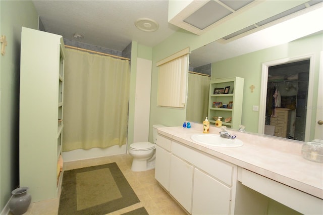 full bathroom featuring shower / bath combo with shower curtain, tile patterned floors, vanity, and toilet