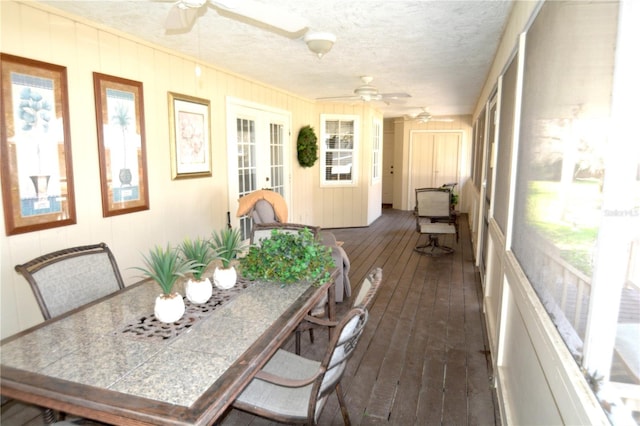 sunroom / solarium featuring ceiling fan