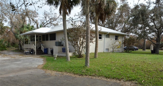 exterior space featuring cooling unit and a lawn