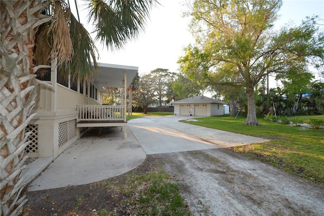 view of yard with a garage and an outbuilding