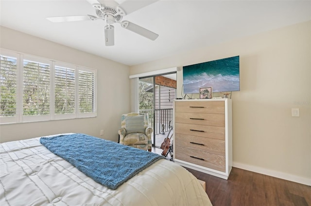 bedroom featuring dark hardwood / wood-style floors, ceiling fan, multiple windows, and a closet