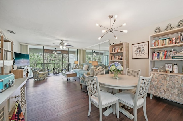 dining room featuring a wall of windows, ceiling fan with notable chandelier, and dark wood-type flooring