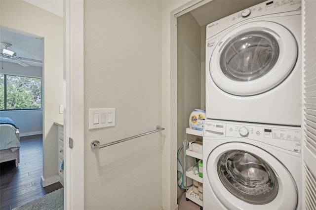 laundry room with ceiling fan, wood-type flooring, and stacked washer / dryer